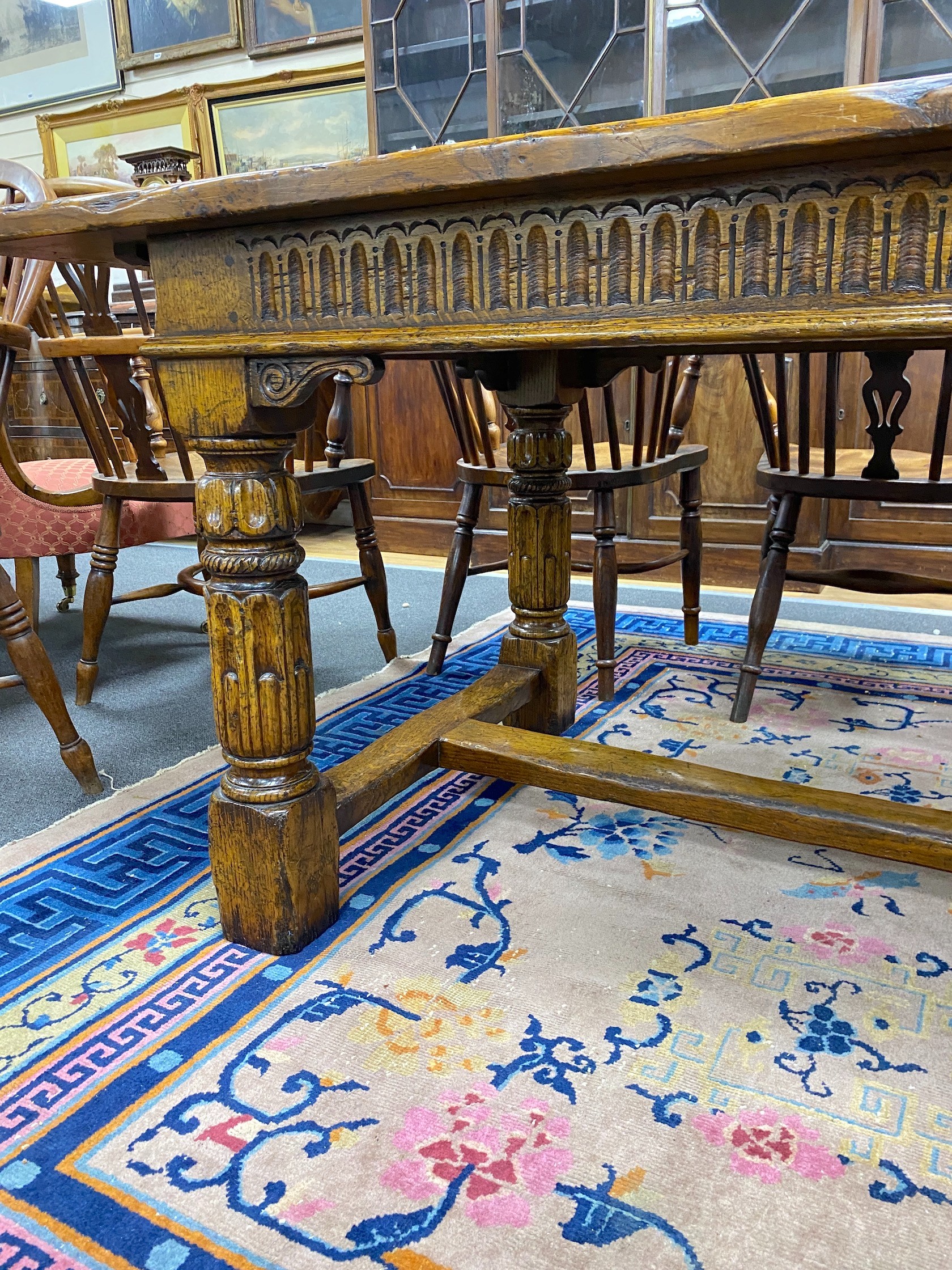 An 18th century style rectangular pale oak refectory dining table with central stretcher and two detachable extending leaves, (lacking three bolts) length 244cm, width 91cm, height 75cm, extending leaves each 46cm